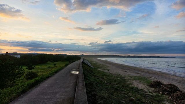 The sea wall path along the coast at sunset